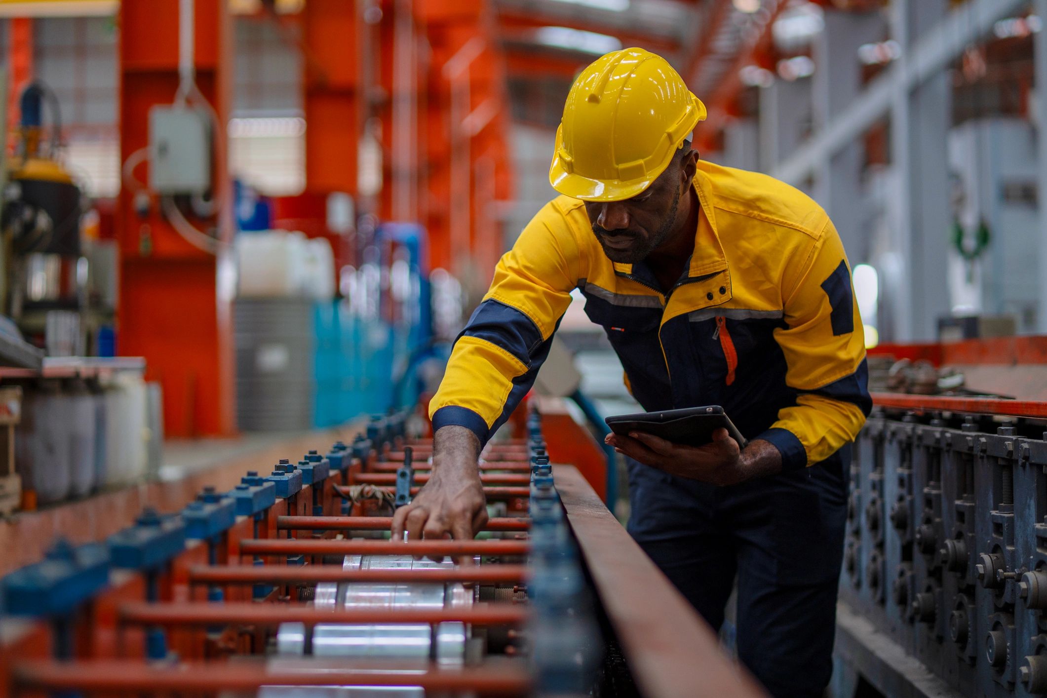 Industrial worker inspecting parts in a factory setting